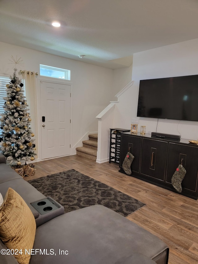 foyer with a textured ceiling and light hardwood / wood-style flooring