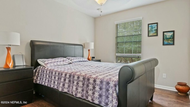 bedroom with dark wood-type flooring