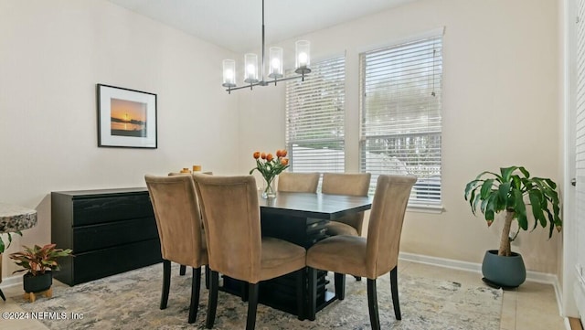 dining room featuring a notable chandelier, plenty of natural light, and light tile patterned floors