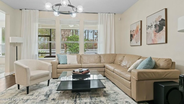 living room with hardwood / wood-style flooring and an inviting chandelier