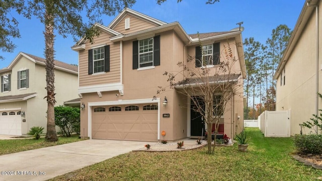 view of front of home with a garage and a front lawn