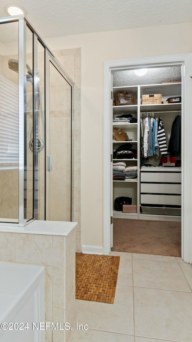 bathroom featuring tile patterned floors and a shower with door