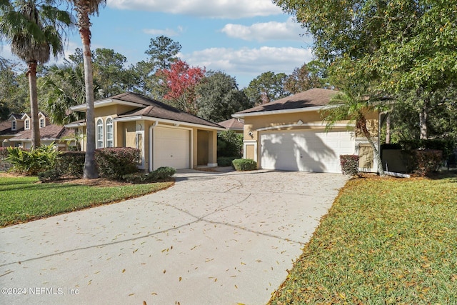 view of front facade featuring a garage and a front lawn