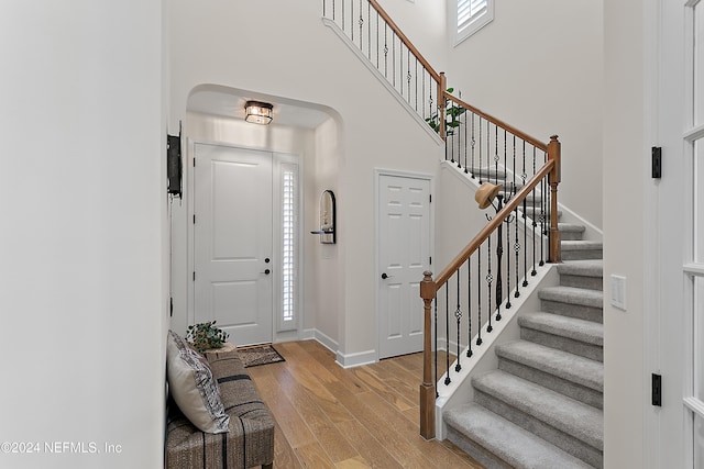 entrance foyer featuring light wood-type flooring and a high ceiling