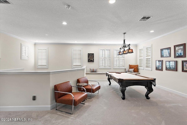 recreation room featuring a textured ceiling, light colored carpet, crown molding, and billiards