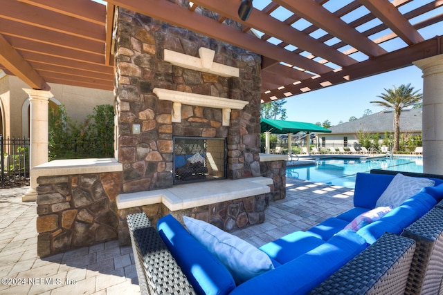 view of patio / terrace with an outdoor living space with a fireplace, a pergola, and a community pool