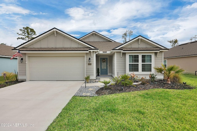 view of front of property featuring a front yard and a garage