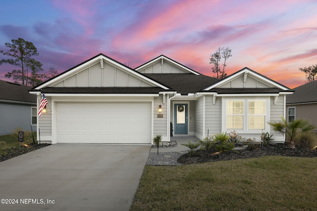 view of front of house featuring a garage and a lawn