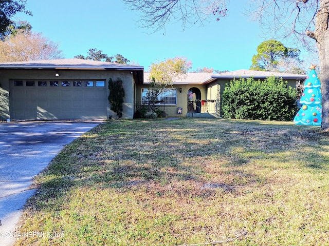 single story home featuring a front yard and a garage