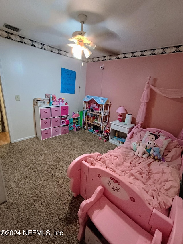 carpeted bedroom featuring a ceiling fan and visible vents