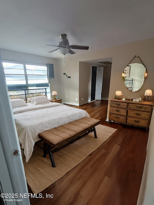 bedroom featuring ceiling fan, baseboards, and wood finished floors