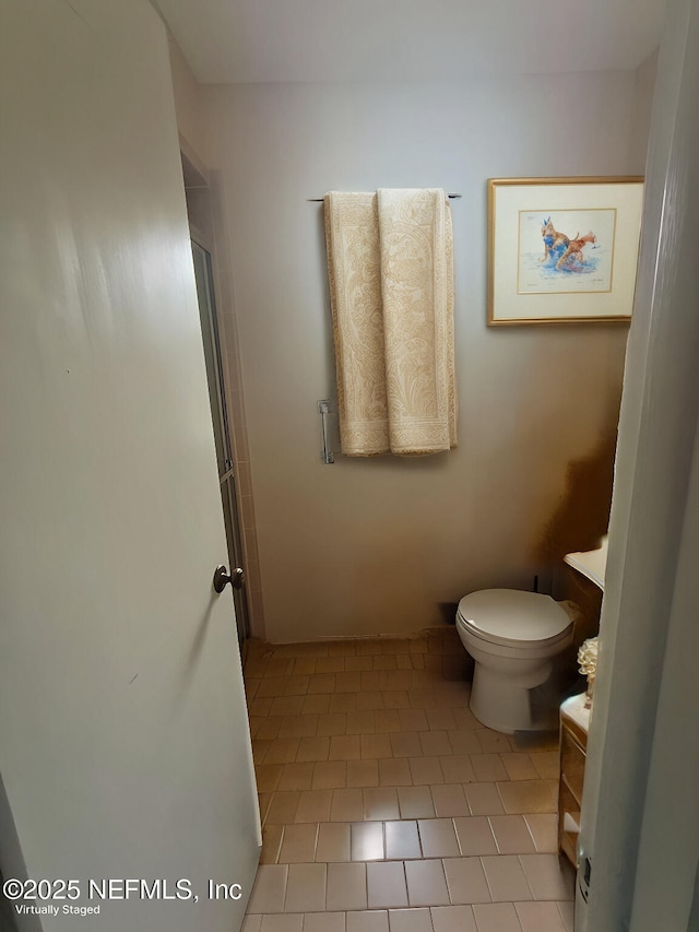 full bath featuring vanity, tile patterned floors, and toilet