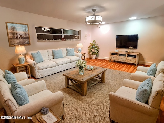 living room with baseboards and wood finished floors