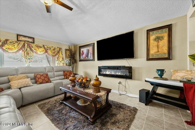 tiled living room featuring ceiling fan and a textured ceiling