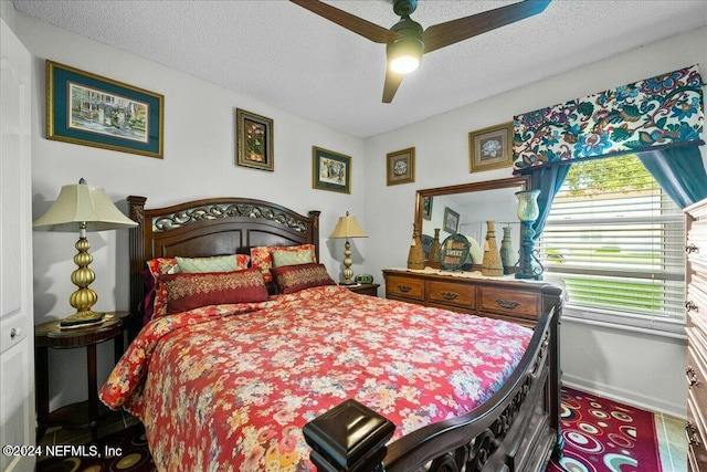 bedroom with ceiling fan and a textured ceiling