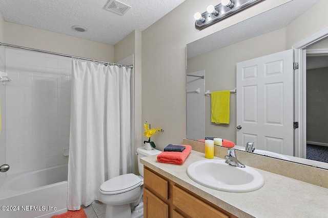 full bathroom with tile patterned floors, vanity, a textured ceiling, shower / tub combo with curtain, and toilet