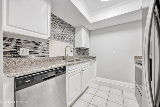 kitchen with white cabinets, sink, ornamental molding, appliances with stainless steel finishes, and tasteful backsplash