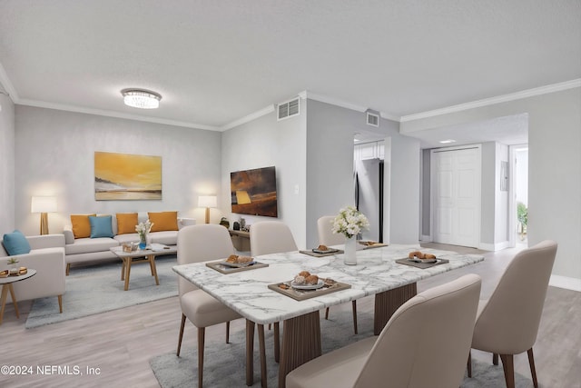 dining space featuring hardwood / wood-style floors and ornamental molding