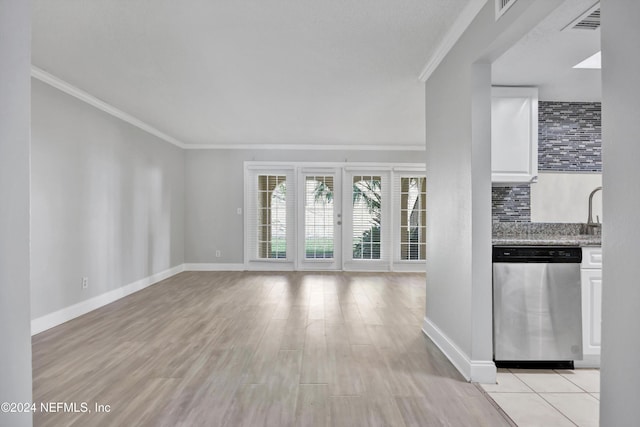 unfurnished living room featuring light hardwood / wood-style flooring and ornamental molding