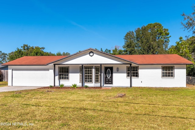 ranch-style house with a front lawn, covered porch, and a garage