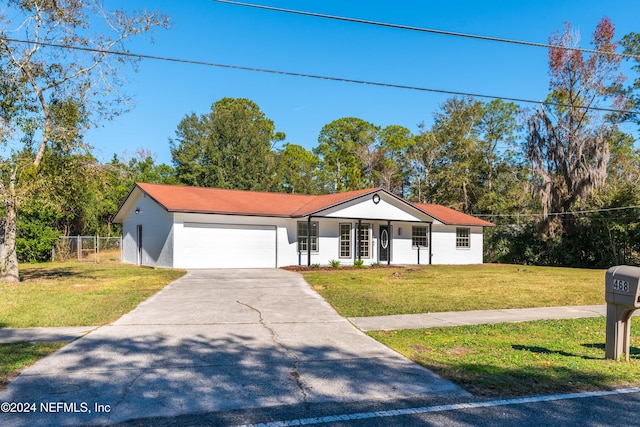 view of front of home with a front yard and a garage