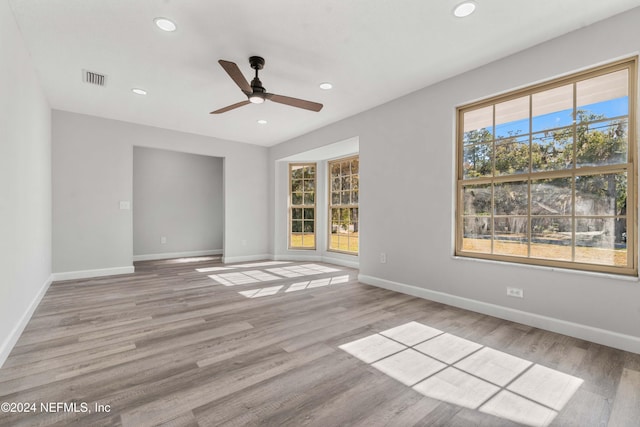 empty room featuring ceiling fan and light hardwood / wood-style flooring