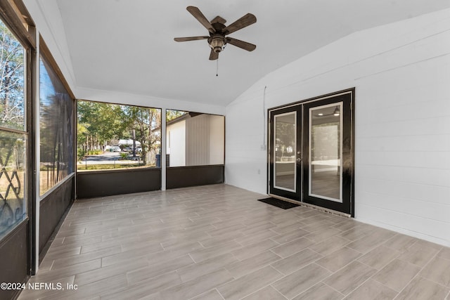 unfurnished sunroom with ceiling fan and vaulted ceiling