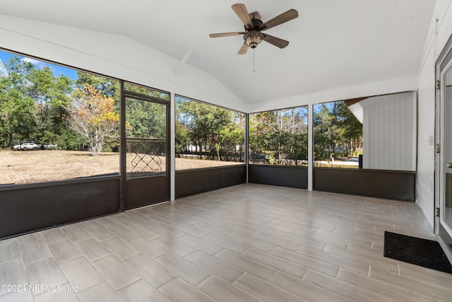 unfurnished sunroom featuring ceiling fan and vaulted ceiling