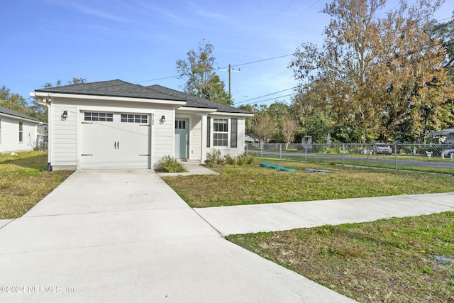 view of front of home with a garage and a front yard