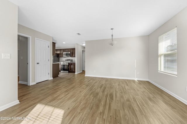 unfurnished living room featuring light wood-type flooring