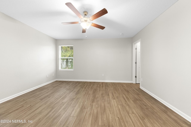 empty room featuring ceiling fan and light hardwood / wood-style flooring