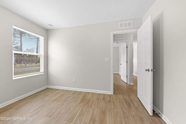 unfurnished room with light hardwood / wood-style flooring