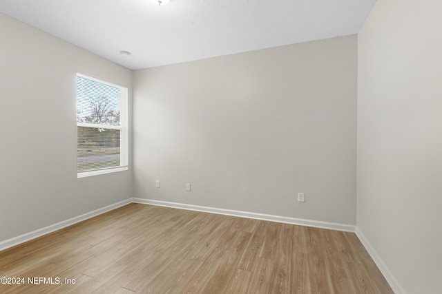 unfurnished room with light wood-type flooring