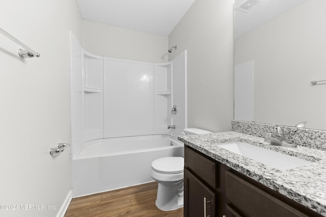 full bathroom with wood-type flooring, vanity, bathing tub / shower combination, and toilet