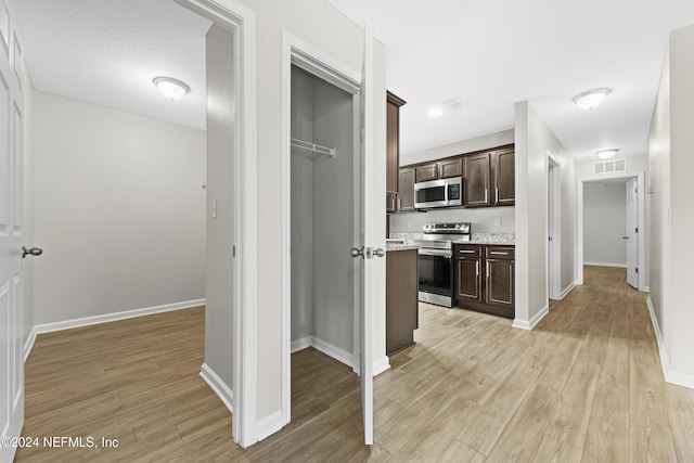 hall with light hardwood / wood-style flooring