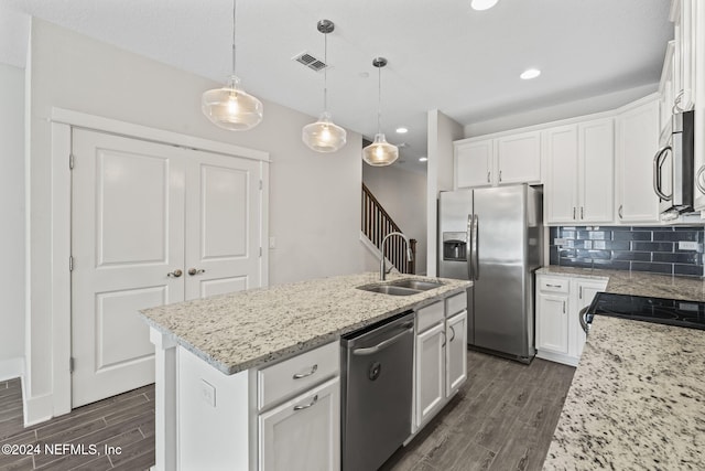 kitchen featuring white cabinetry, sink, dark hardwood / wood-style floors, an island with sink, and appliances with stainless steel finishes