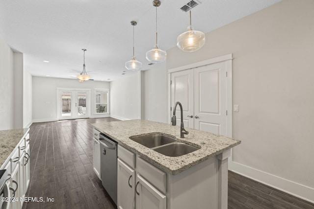 kitchen with dishwasher, sink, hanging light fixtures, dark hardwood / wood-style flooring, and a center island with sink