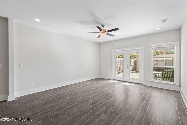 spare room featuring french doors, a textured ceiling, ceiling fan, and dark wood-type flooring