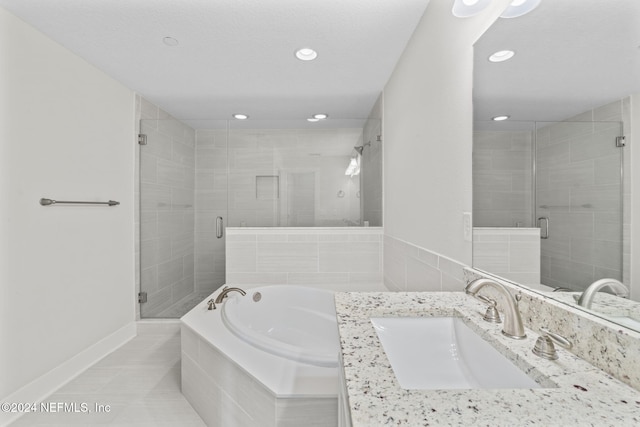 bathroom with tile patterned floors, vanity, and plus walk in shower