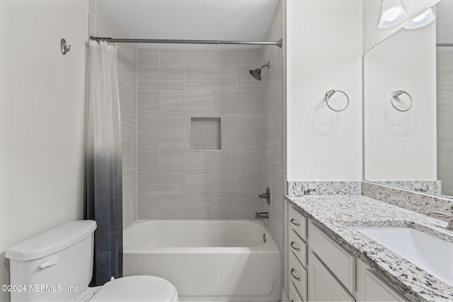 full bathroom featuring vanity, toilet, a textured ceiling, and shower / tub combo