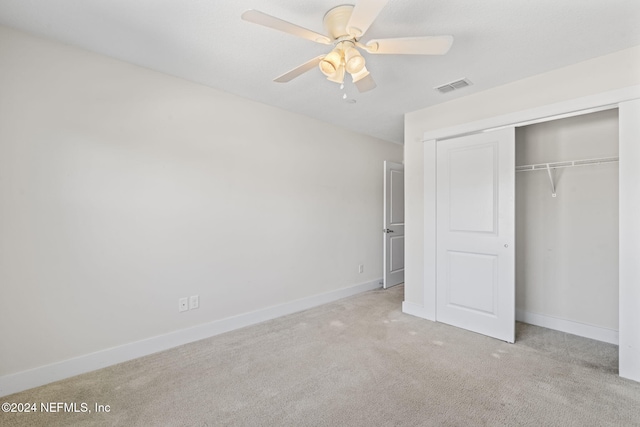 unfurnished bedroom with a closet, ceiling fan, and light colored carpet