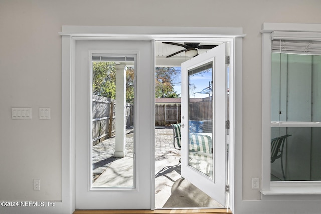 doorway to outside featuring ceiling fan