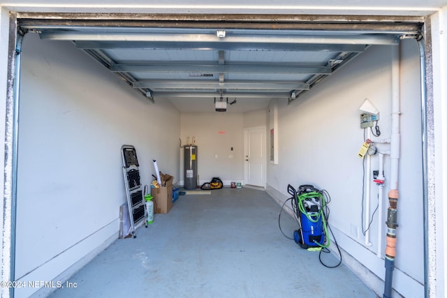 garage featuring electric water heater and a garage door opener