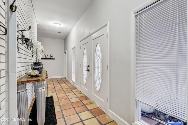 entryway with light tile patterned floors