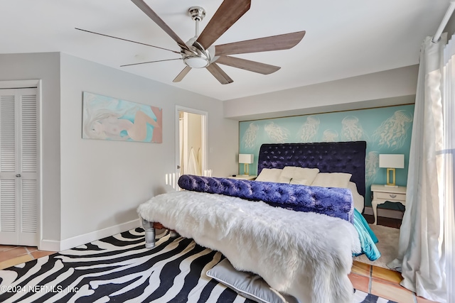 tiled bedroom featuring a closet and ceiling fan