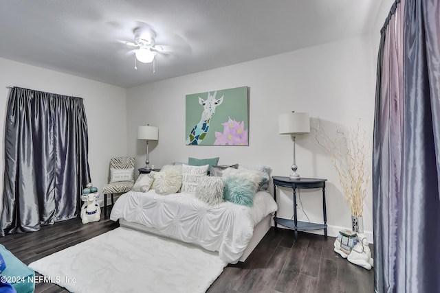 bedroom with dark hardwood / wood-style floors and ceiling fan