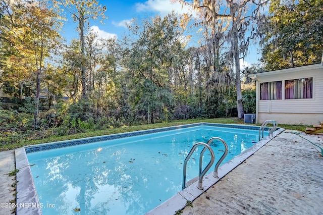 view of swimming pool with central AC unit