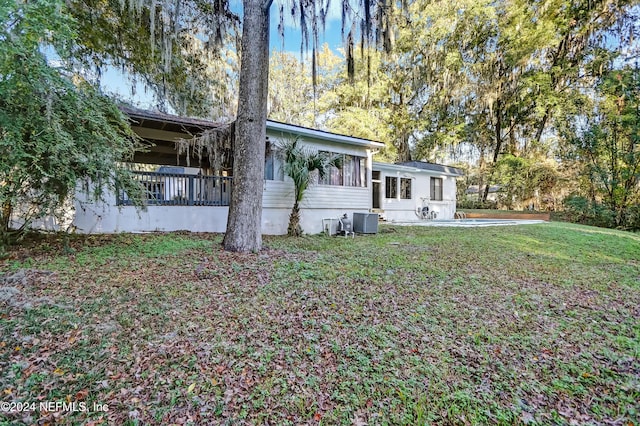 exterior space with a yard and cooling unit