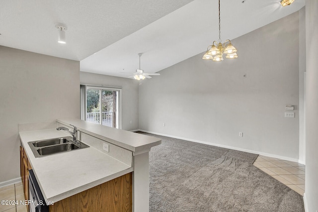 kitchen featuring sink, pendant lighting, lofted ceiling, light carpet, and ceiling fan with notable chandelier