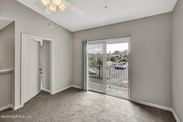 carpeted empty room featuring vaulted ceiling and ceiling fan